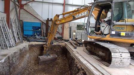 Excavating the large pit to take the depth of the flywheel.