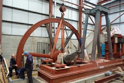 Flywheel and crankshaft, in place, on the bedplate. An additional sling is used on the crank to help the out of balance.