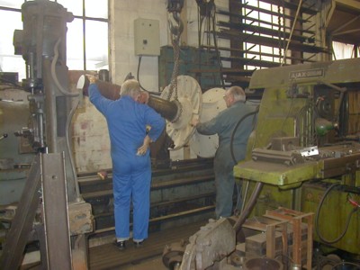 Removing the paddle wheel hub and shaft from the lathe. Note the new machined left hand end.