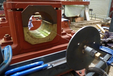 The piano wire, running through the centre of the outer bearing, together with the wire tensioning arrangement on the right.