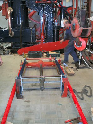 Piston rod, cross-head and side rod assembly, on the floor ready for hoisting up into place.